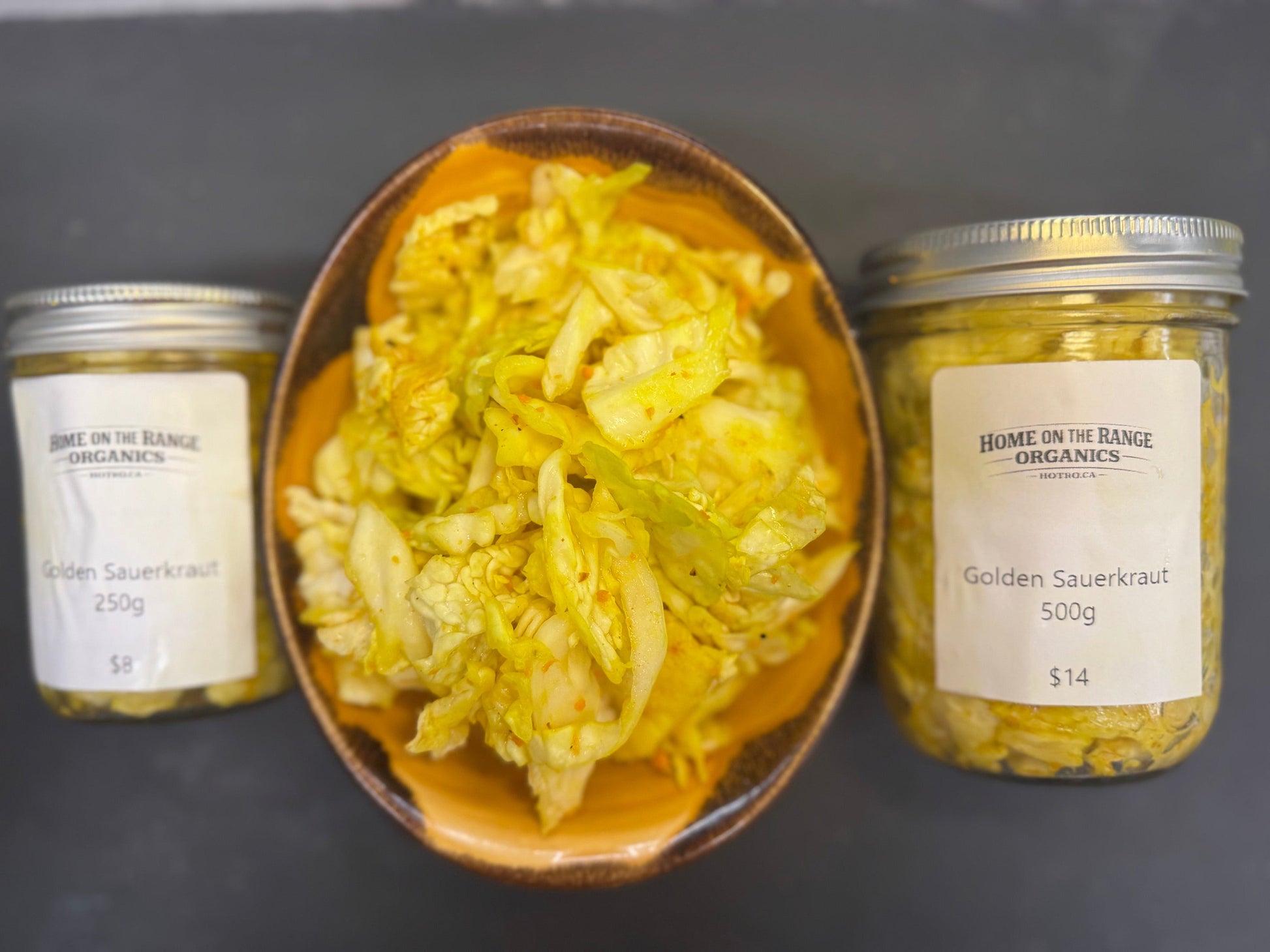 A photo of a bowl of sauerkraut and two sizes of jars for sale (500g and 250g)