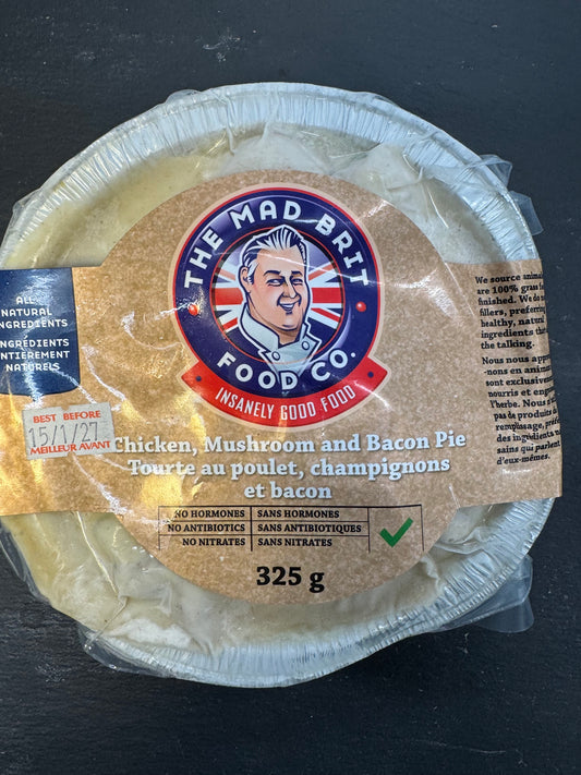 A packaged round pie from The Mad Brit Food Co. labeled 'Chicken, Mushroom and Bacon Pie' on a dark textured background.